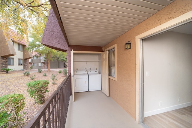 view of patio featuring a balcony and independent washer and dryer