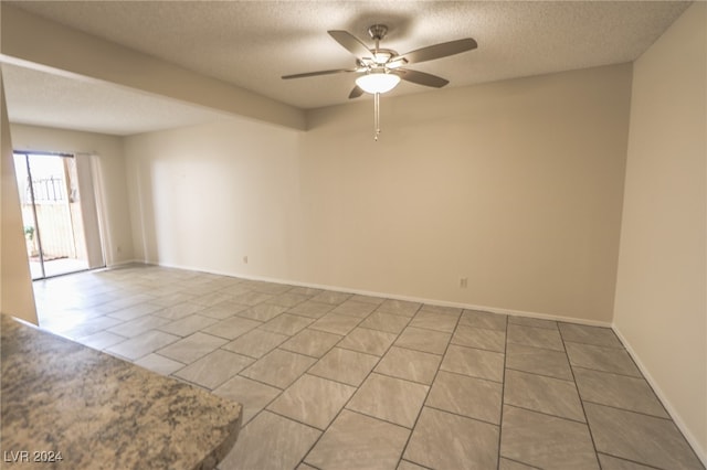 unfurnished room featuring a textured ceiling and ceiling fan