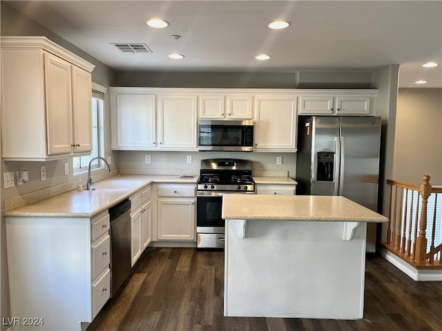 kitchen featuring sink, white cabinets, stainless steel appliances, and dark hardwood / wood-style floors