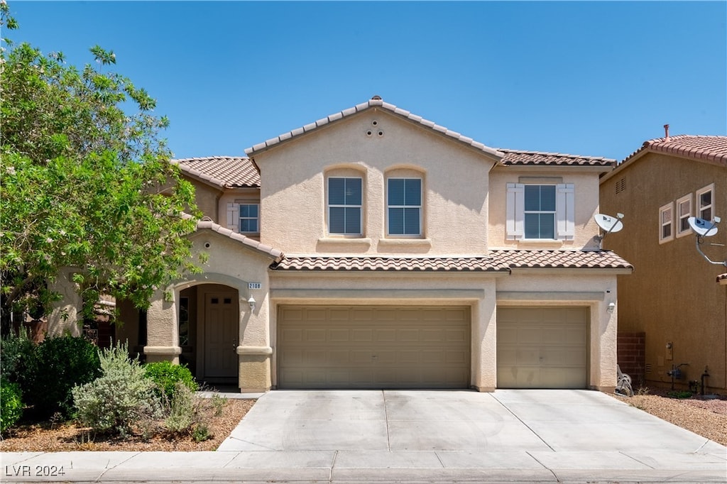 mediterranean / spanish house with a garage