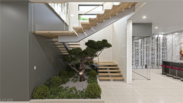 stairway with recessed lighting and tile patterned floors