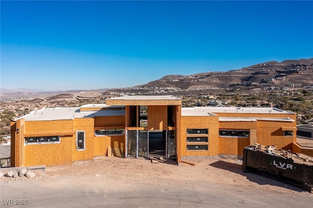 view of front of property with a mountain view and stucco siding