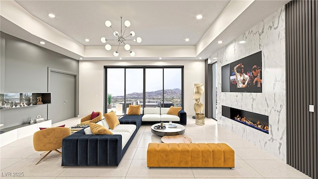 living area featuring tile patterned floors, a premium fireplace, a notable chandelier, and recessed lighting