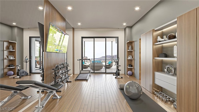 exercise room with recessed lighting, plenty of natural light, and wood finished floors