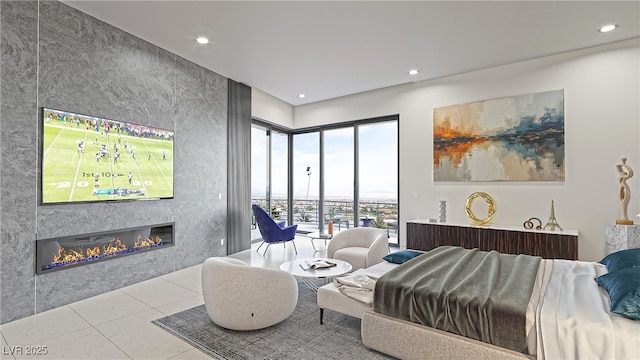 tiled bedroom with access to exterior, recessed lighting, and a glass covered fireplace