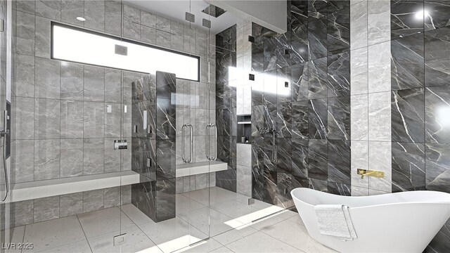 full bathroom with tile walls, a freestanding bath, and a shower stall