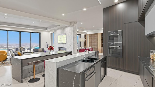 1487 Reims Dr, Henderson, NV 89012 - kitchen featuring double oven, a sink, modern cabinets, and open floor plan