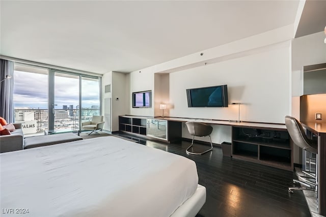 bedroom featuring access to outside, expansive windows, and hardwood / wood-style flooring