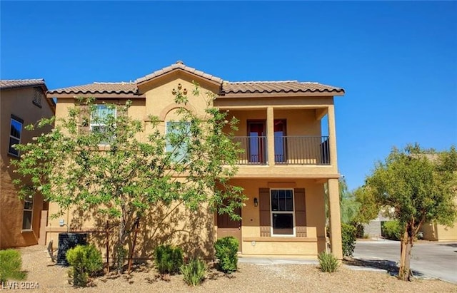 mediterranean / spanish-style home with a balcony