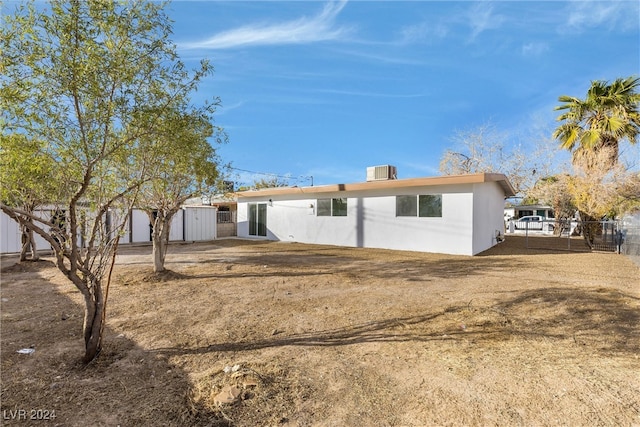 back of property featuring a storage shed