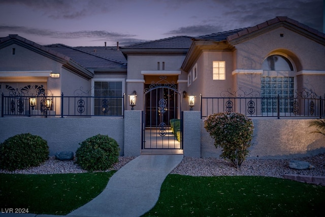 exterior entry at dusk with a garage