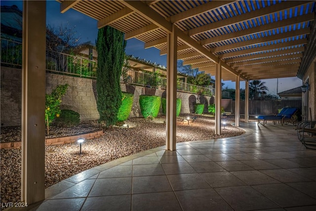 patio terrace at dusk featuring a pergola