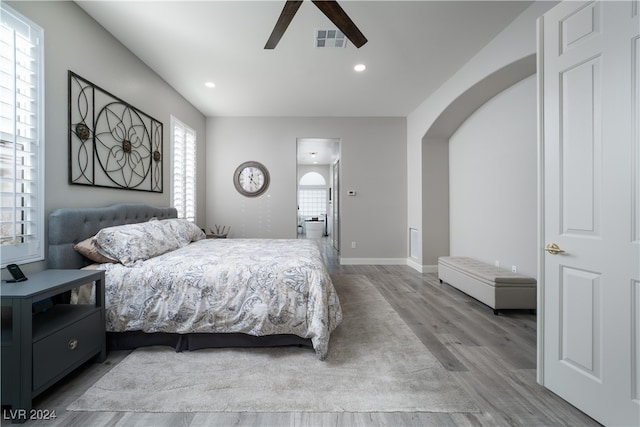 bedroom with light hardwood / wood-style floors and ceiling fan