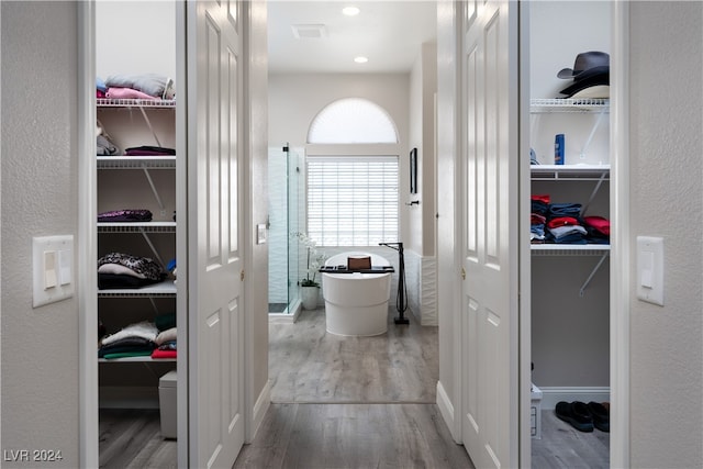 bathroom with hardwood / wood-style floors and a bathing tub