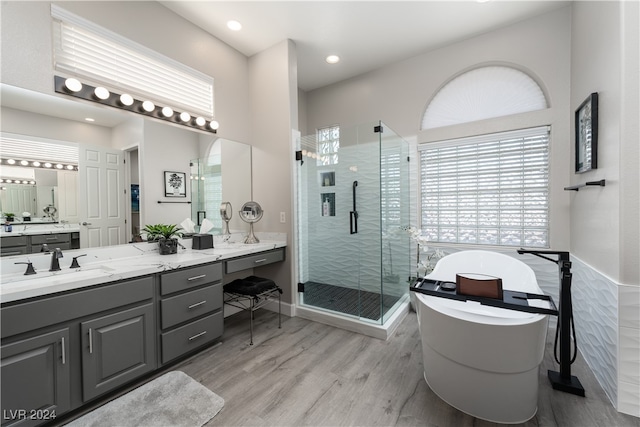 bathroom with shower with separate bathtub, vanity, and hardwood / wood-style floors