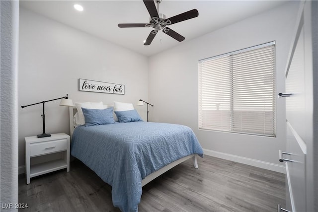 bedroom with dark hardwood / wood-style floors and ceiling fan