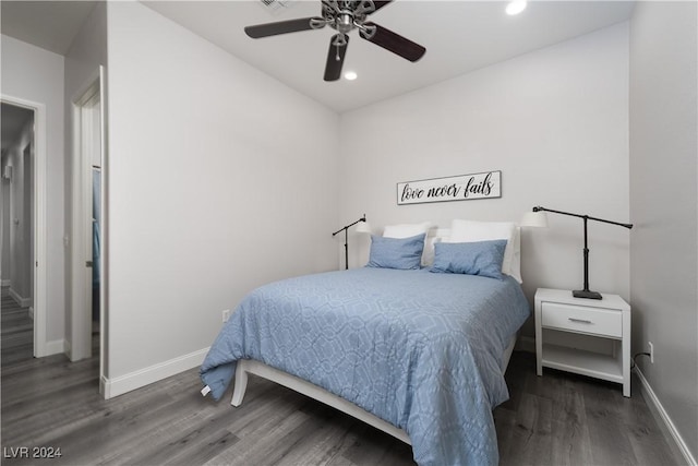 bedroom with ceiling fan and dark wood-type flooring