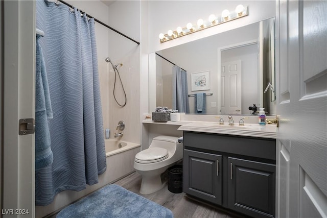 full bathroom with hardwood / wood-style floors, vanity, toilet, and shower / bath combo with shower curtain