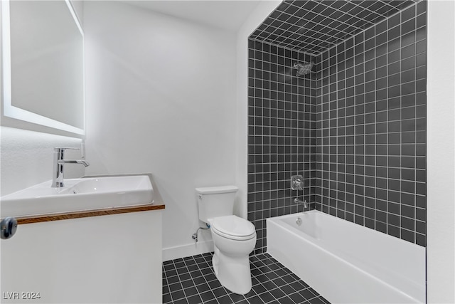 full bathroom featuring tile patterned floors, vanity, tiled shower / bath combo, and toilet