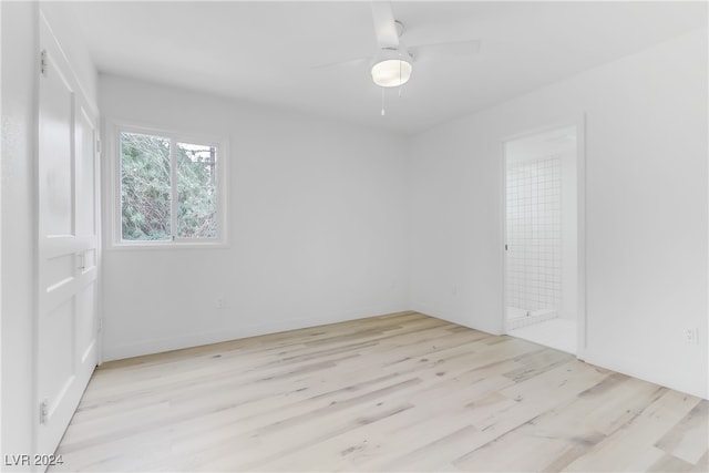 spare room with light wood-type flooring and ceiling fan