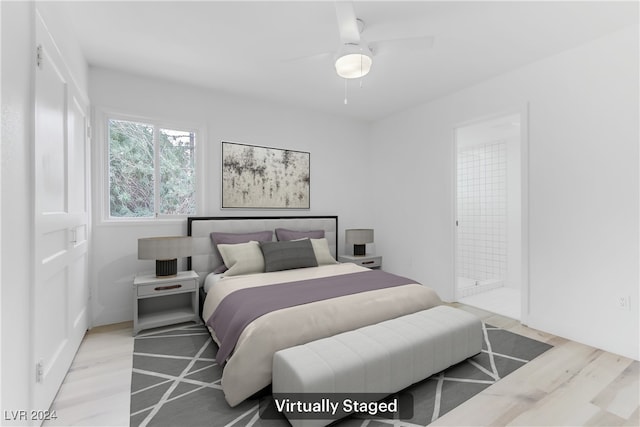 bedroom with ceiling fan, ensuite bathroom, and light hardwood / wood-style flooring