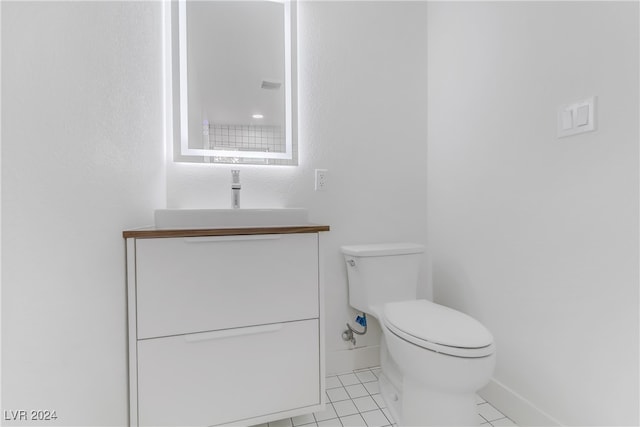 bathroom featuring tile patterned flooring, vanity, and toilet