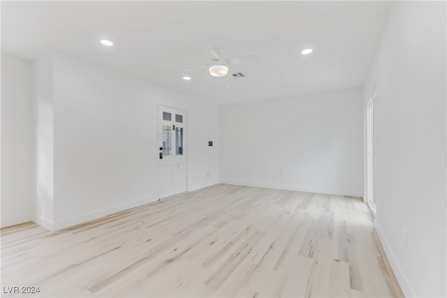 empty room with ceiling fan and light wood-type flooring