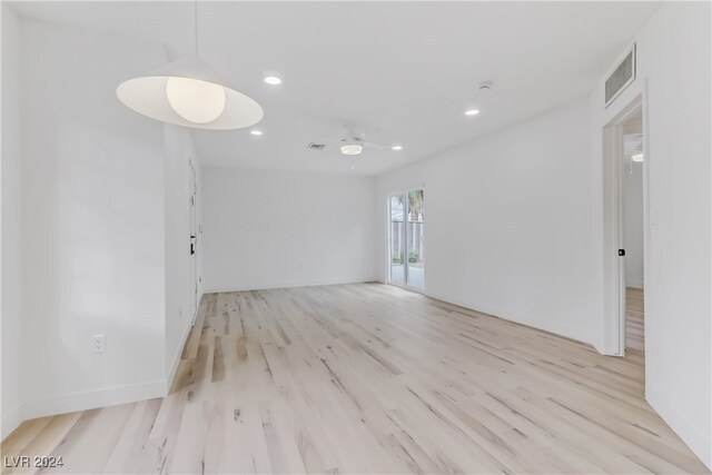 empty room featuring light hardwood / wood-style flooring and ceiling fan