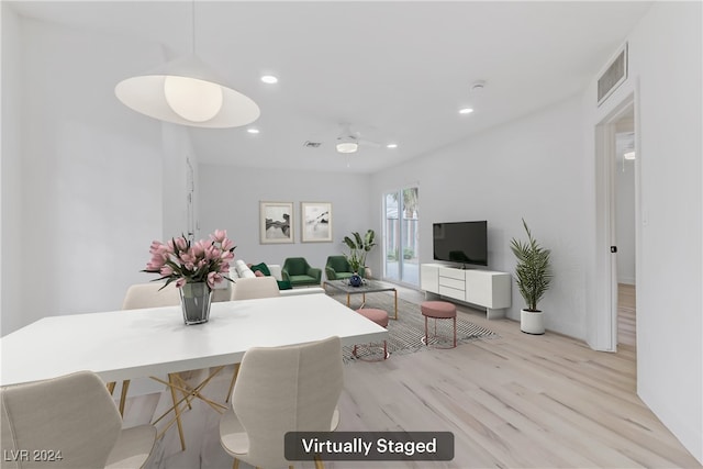 dining room with ceiling fan and light hardwood / wood-style floors