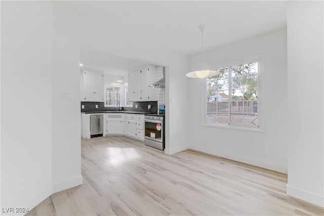 kitchen with white cabinets, light hardwood / wood-style floors, sink, and stainless steel appliances