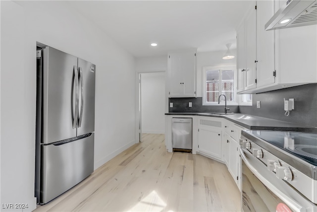 kitchen featuring stainless steel appliances, sink, light hardwood / wood-style flooring, white cabinetry, and range hood