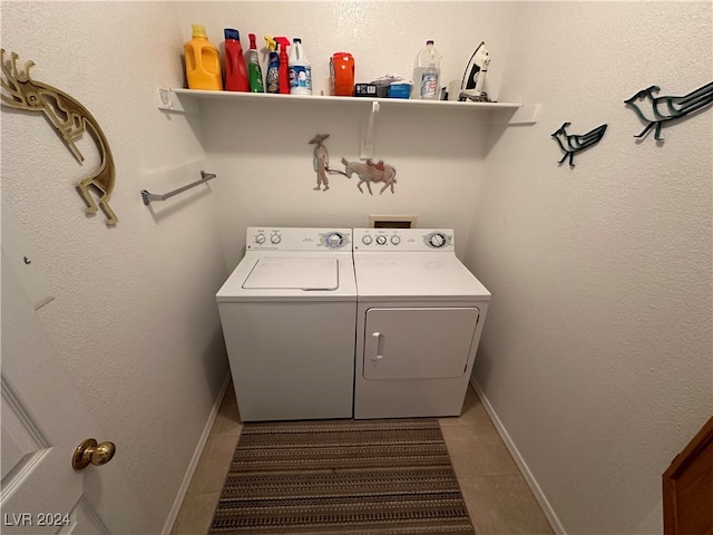 washroom with tile patterned flooring and washing machine and clothes dryer