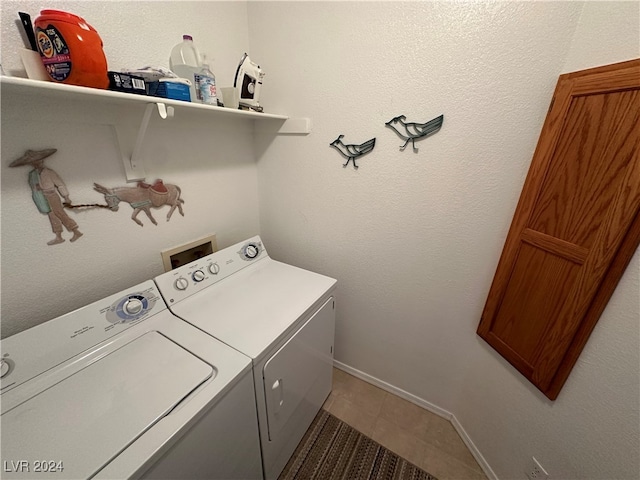 washroom with tile patterned flooring and washer and clothes dryer