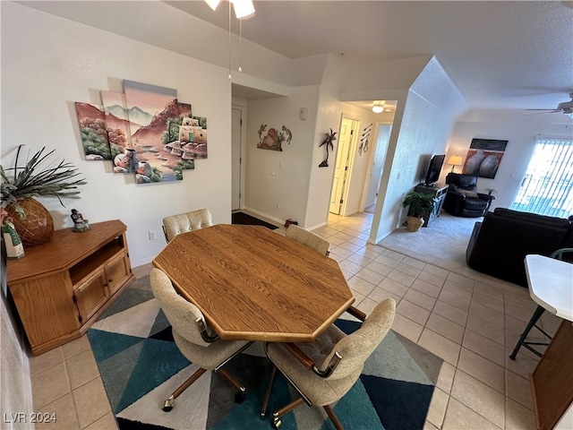 dining space with ceiling fan and light tile patterned floors