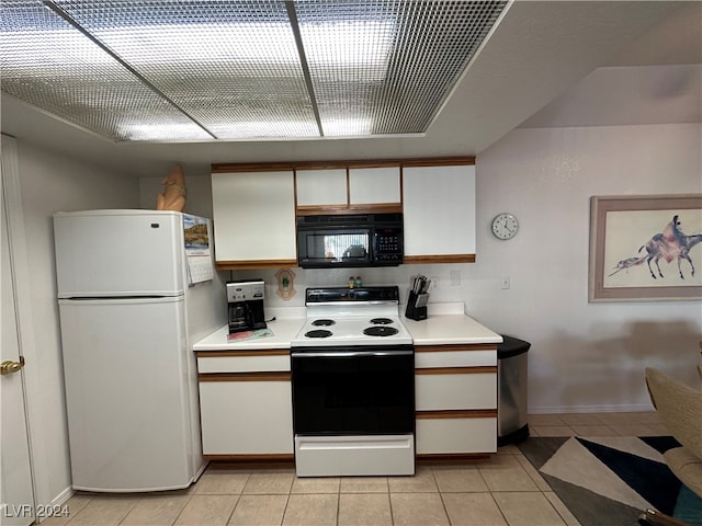 kitchen with white cabinetry, light tile patterned flooring, and white appliances