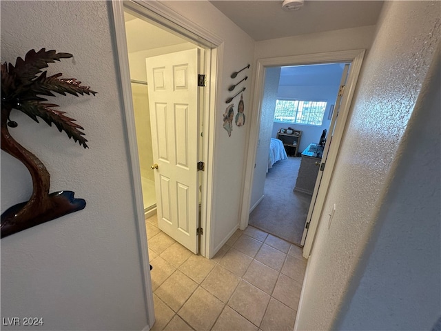 hall with light tile patterned flooring