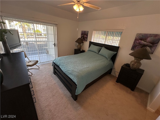 carpeted bedroom with ceiling fan and access to outside