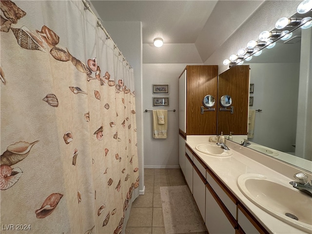 bathroom featuring tile patterned flooring, a textured ceiling, and vanity