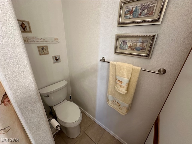 bathroom with toilet and tile patterned floors