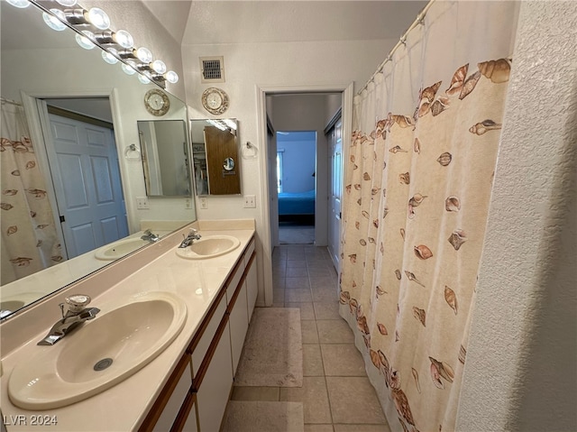 bathroom with tile patterned flooring and vanity