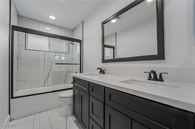 full bathroom with toilet, vanity, and bath / shower combo with glass door