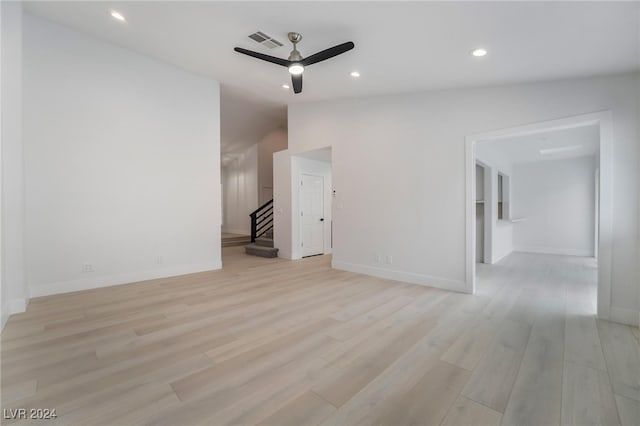 spare room with vaulted ceiling, ceiling fan, and light hardwood / wood-style floors