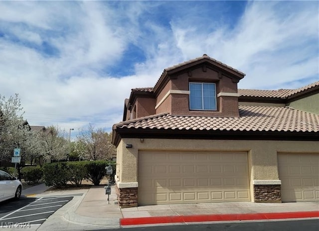 view of side of home featuring a garage