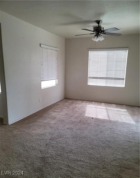 unfurnished room featuring carpet flooring, plenty of natural light, and ceiling fan