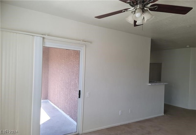 unfurnished room with carpet flooring and ceiling fan