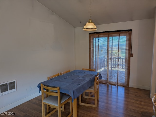 dining space with dark hardwood / wood-style flooring and vaulted ceiling