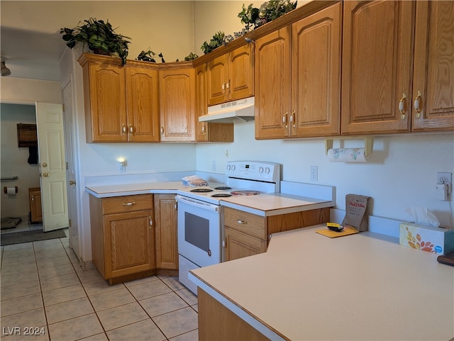 kitchen with electric stove, kitchen peninsula, and light tile patterned floors