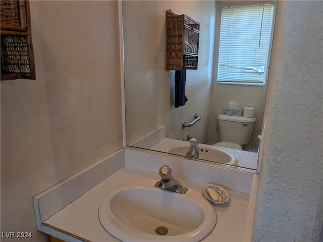 bathroom with vanity and toilet