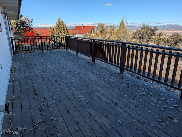 wooden deck with a mountain view