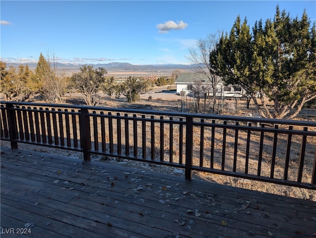 wooden deck featuring a mountain view